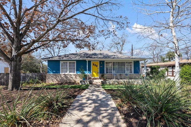 view of front facade with a porch and fence