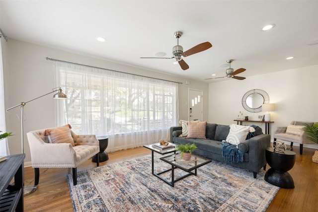 living room featuring recessed lighting, wood finished floors, and a healthy amount of sunlight