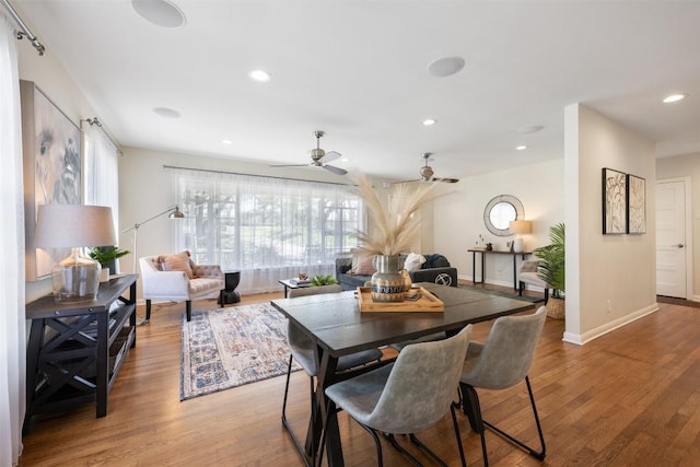 dining space with baseboards, ceiling fan, wood finished floors, and recessed lighting