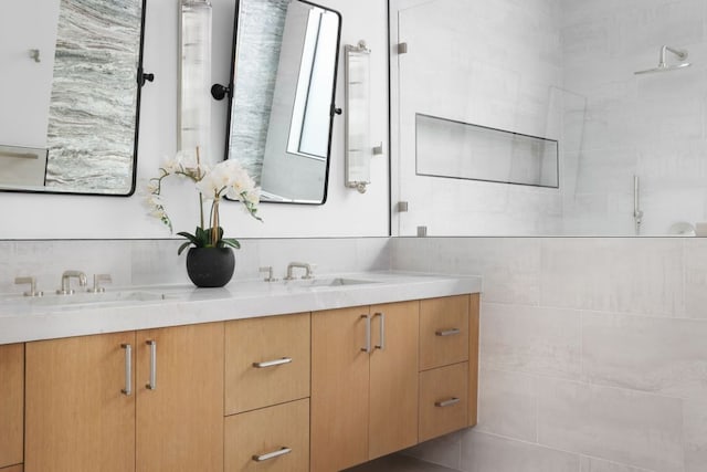 bathroom with double vanity, tasteful backsplash, and a sink