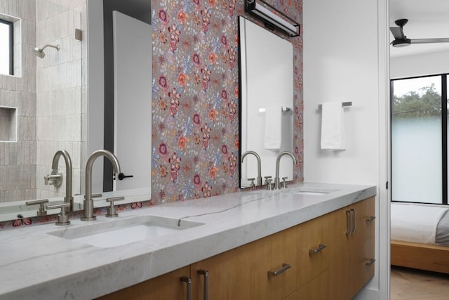 bathroom with double vanity, ensuite bath, and a sink