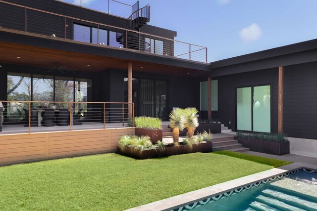 1704 Newton St, Austin, TX 78704 - back of house with a balcony, a ceiling fan, and a yard
