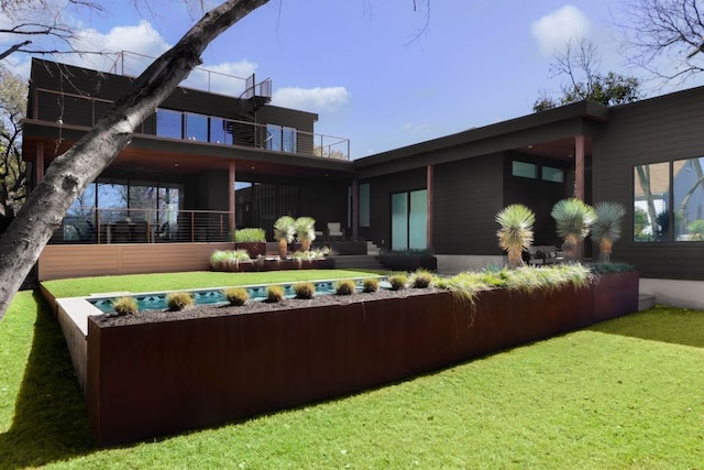 1704 Newton St, Austin, TX 78704 - back of property featuring a yard and a balcony