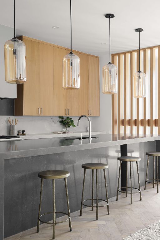 1704 Newton St, Austin, TX 78704 - kitchen featuring light brown cabinetry, a breakfast bar, hanging light fixtures, and modern cabinets