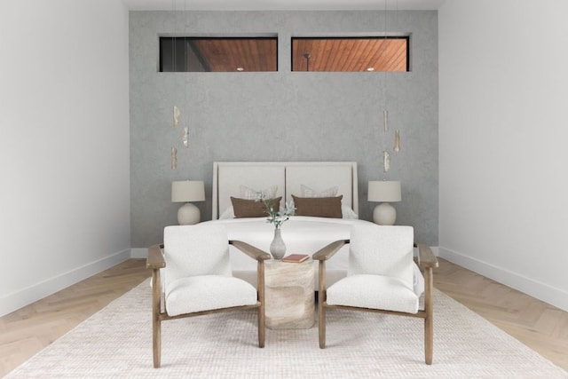 bedroom featuring light wood finished floors and baseboards