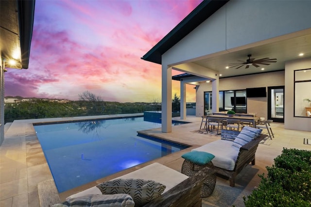 pool featuring outdoor dining space, a patio area, and ceiling fan