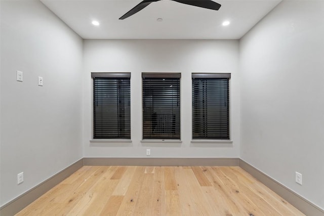 spare room with a ceiling fan, recessed lighting, wood finished floors, and baseboards