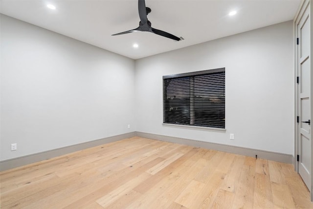 spare room with a ceiling fan, recessed lighting, wood finished floors, and baseboards