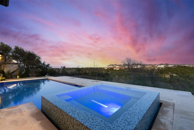 view of swimming pool featuring a patio area and a pool with connected hot tub