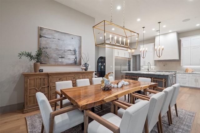 dining space with light wood finished floors, recessed lighting, and baseboards