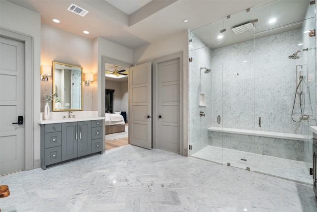 full bathroom featuring ceiling fan, visible vents, a stall shower, and vanity