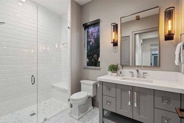 full bath featuring a stall shower, toilet, and vanity