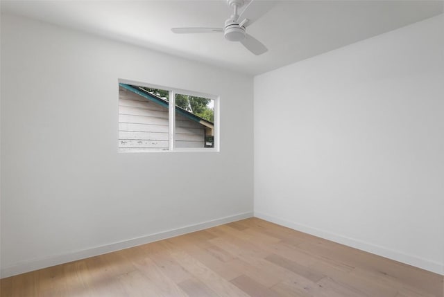 spare room with a ceiling fan, baseboards, and wood finished floors