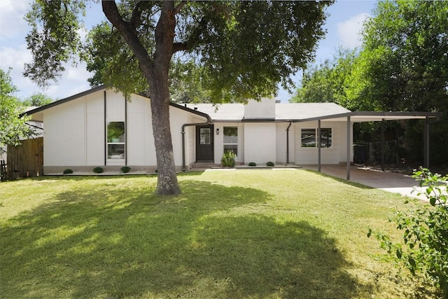 view of front of home featuring a carport, a front yard, and fence