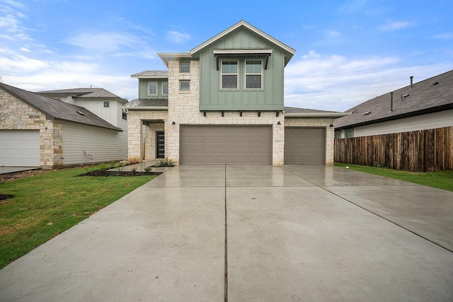 13224 Ditka Dr, Austin, TX 78652 - view of front of home with board and batten siding, stone siding, concrete driveway, and an attached garage