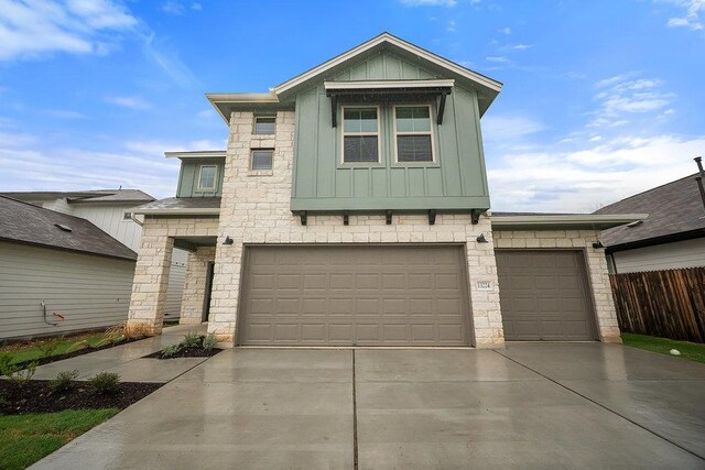 13224 Ditka Dr, Austin, TX 78652 - view of front of property featuring board and batten siding, stone siding, concrete driveway, and an attached garage