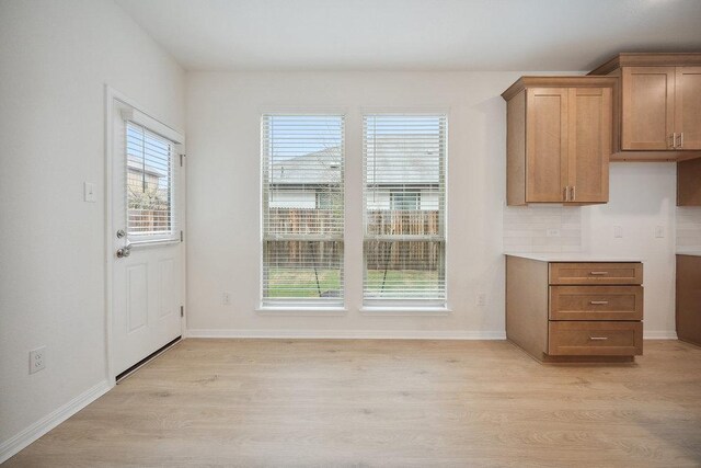 13224 Ditka Dr, Austin, TX 78652 - unfurnished dining area with light wood-type flooring and baseboards