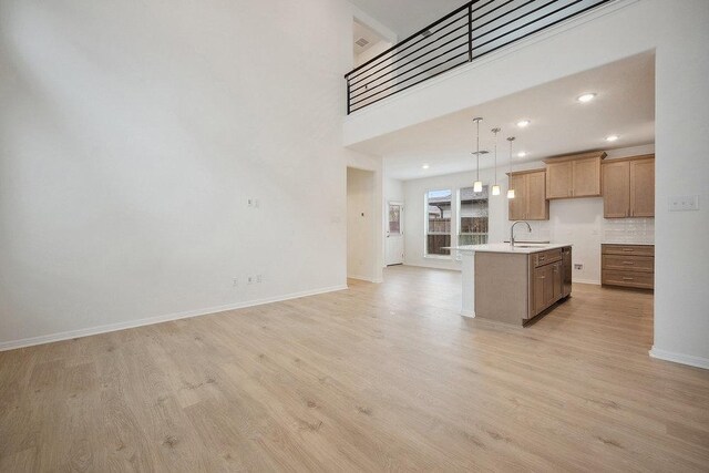 13224 Ditka Dr, Austin, TX 78652 - kitchen featuring a sink, light wood-style floors, pendant lighting, light countertops, and recessed lighting