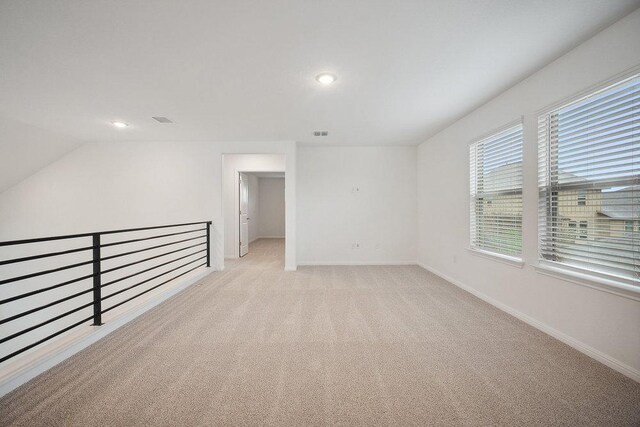 13224 Ditka Dr, Austin, TX 78652 - spare room with light colored carpet, baseboards, recessed lighting, and lofted ceiling