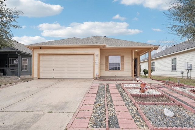 view of front of home featuring roof with shingles, driveway, and an attached garage