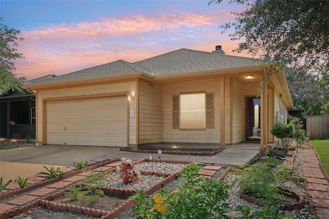 9316 Brents Elm Dr, Austin, TX 78744 - view of front facade with a garage, a chimney, concrete driveway, and a vegetable garden