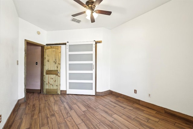 9316 Brents Elm Dr, Austin, TX 78744 - unfurnished bedroom featuring dark wood-style floors and ceiling fan
