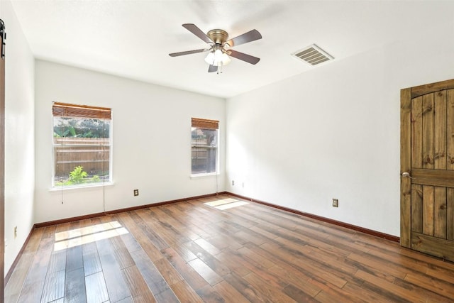 9316 Brents Elm Dr, Austin, TX 78744 - empty room featuring healthy amount of natural light, wood finished floors, and a ceiling fan