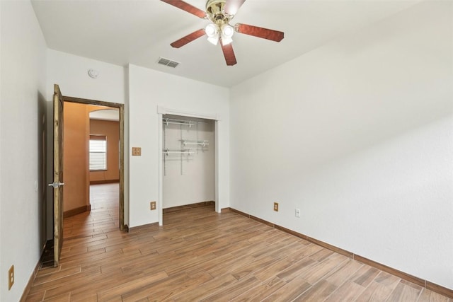 9316 Brents Elm Dr, Austin, TX 78744 - unfurnished bedroom featuring light wood-style flooring, a closet, arched walkways, and ceiling fan