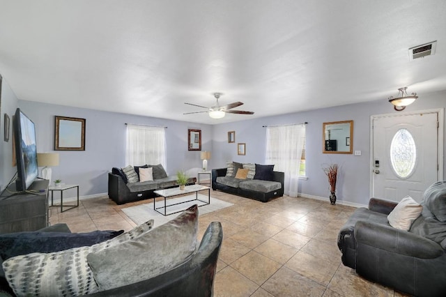 living room featuring a healthy amount of sunlight, light tile patterned floors, baseboards, and visible vents