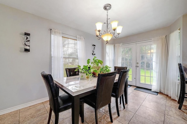 dining room featuring french doors, light tile patterned floors, baseboards, and an inviting chandelier