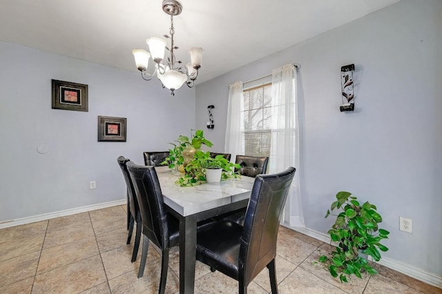 dining room featuring a chandelier, light tile patterned flooring, and baseboards