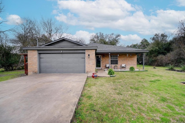 single story home featuring a garage, concrete driveway, brick siding, and a front yard