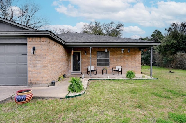 view of front of property with a front yard, brick siding, an attached garage, and roof with shingles