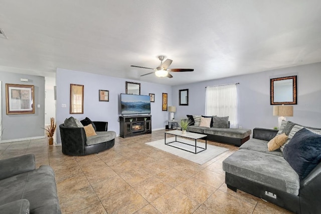 living room with baseboards, visible vents, a ceiling fan, and light tile patterned flooring