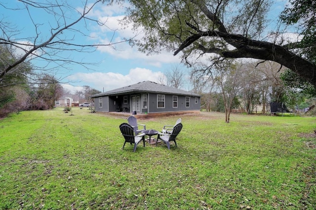 view of yard featuring a trampoline and a fire pit