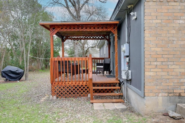 wooden terrace featuring a grill