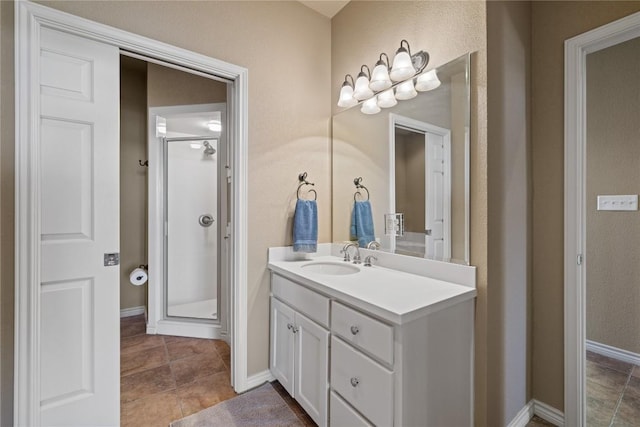 130 Sobrante Rd Unit 309, Belton, TX 76513 - full bathroom featuring vanity, a stall shower, baseboards, and tile patterned flooring