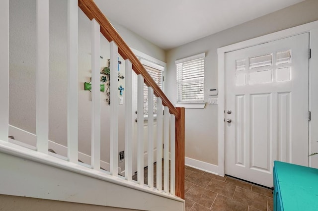 entrance foyer featuring tile patterned flooring and baseboards