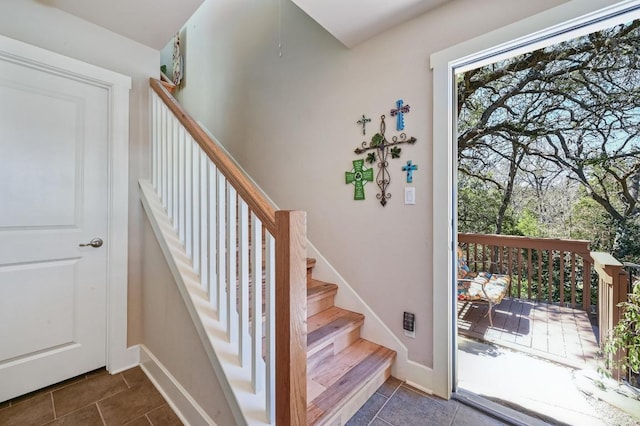 staircase with tile patterned flooring and baseboards