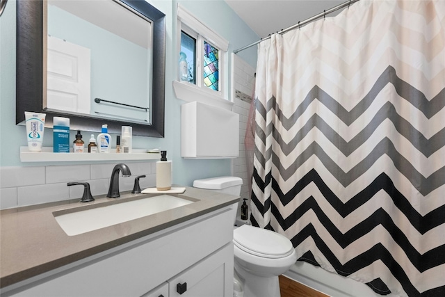 bathroom featuring toilet, a shower with curtain, and vanity