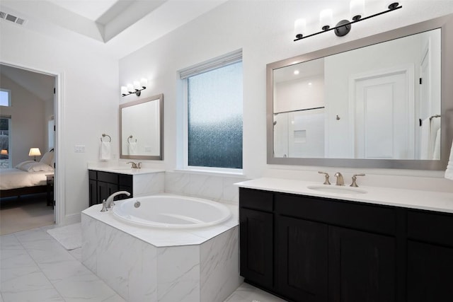 ensuite bathroom featuring marble finish floor, a garden tub, visible vents, vanity, and ensuite bath