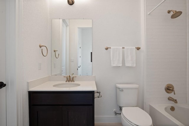 bathroom featuring toilet, bathing tub / shower combination, baseboards, and vanity