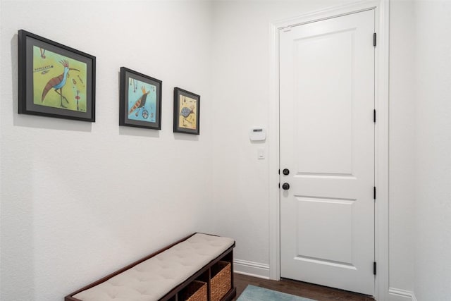 doorway to outside with baseboards and dark wood finished floors