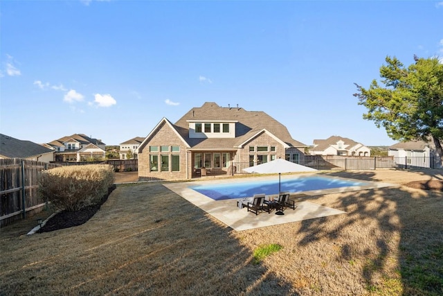 back of property featuring a patio, brick siding, a fenced backyard, and a fenced in pool