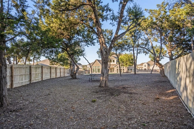 view of yard featuring a fenced backyard and a residential view