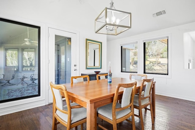 dining area with visible vents, dark wood finished floors, baseboards, and an inviting chandelier