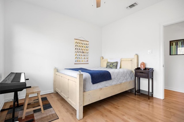 bedroom with light wood-style flooring, visible vents, ceiling fan, and baseboards