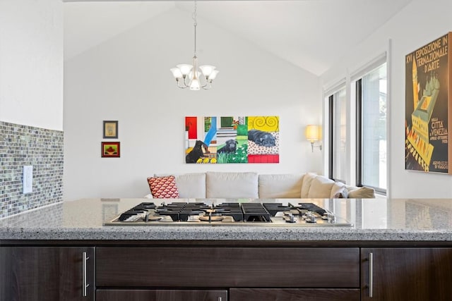 interior space with a chandelier and vaulted ceiling