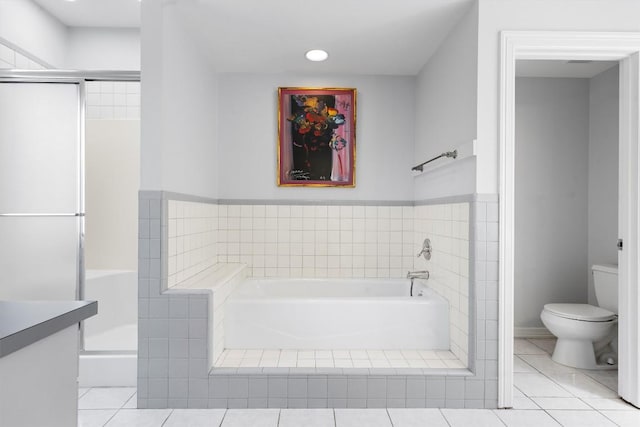 bathroom featuring a bath, a shower stall, toilet, and tile patterned floors