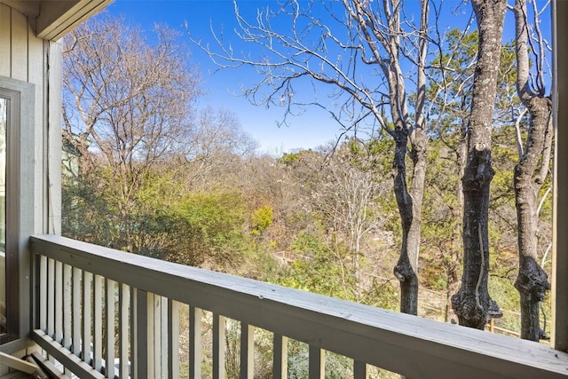 balcony featuring a view of trees